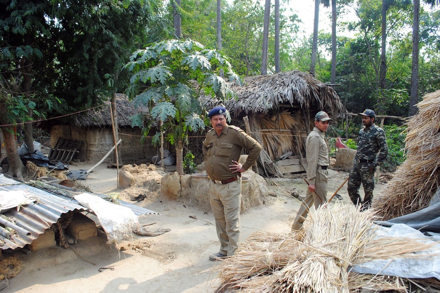 Policemen inspect the site where a woman was gang raped