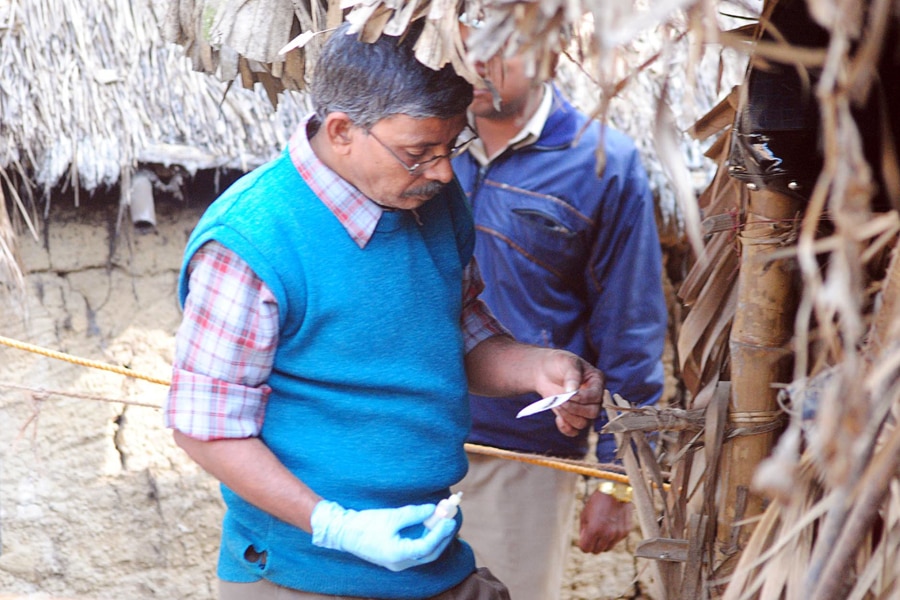 An Indian forensic expert collects evidence from the site where a woman was gang raped