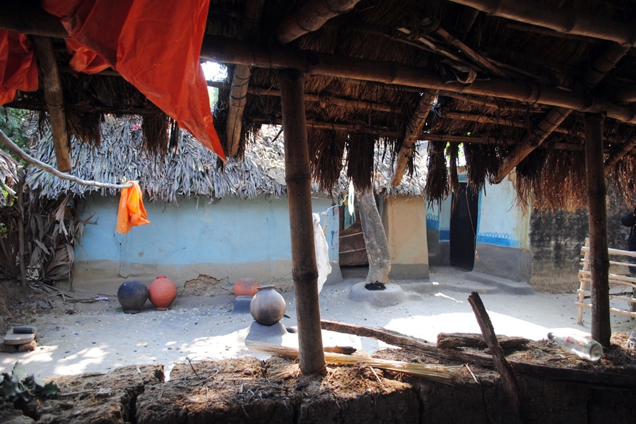 Empty vessels lie in the courtyard of the house of a woman who was gang raped