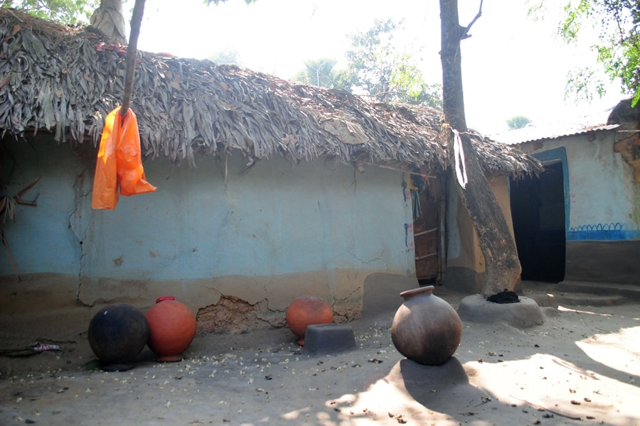 Empty vessels lie in the courtyard of the home of the woman who was gang raped