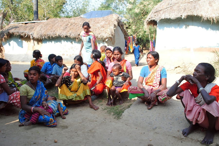 Santhal tribal women gather in a village where a woman was gang raped, allegedly on the direction of a village council at Subalpur