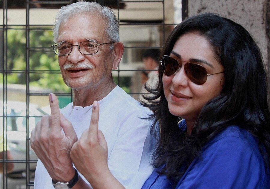 Poet Gulzar and his daughter display their inked fingers after casting their votes in Mumbai.