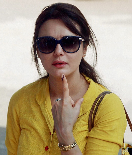 Bollywood actress Preeti Zinta shows her inked finger after casting her vote in Mumbai.