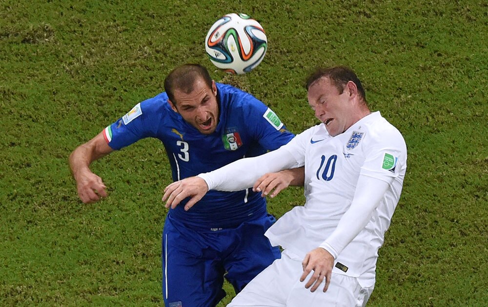 Italy's Giorgio Chiellini, left, and England's Wayne Rooney go for a header during the group D World Cup soccer match between England and Italy at the Arena da Amazonia in Manaus, Brazil.