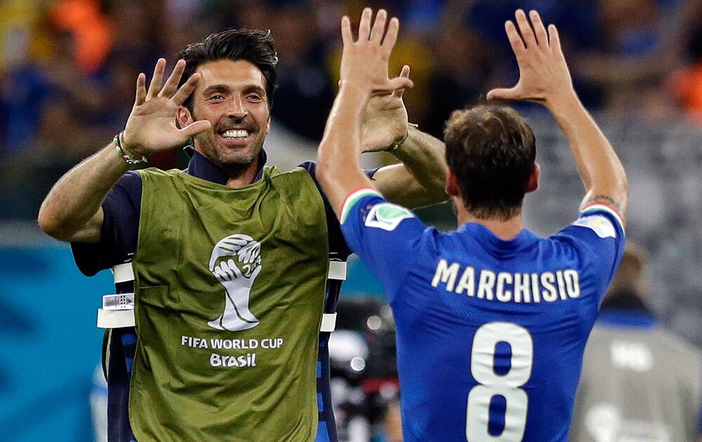 Italy's goalkeeper Gianluigi Buffon, left, celebrates with Claudio Marchisio after the group D World Cup soccer match between England and Italy at the Arena da Amazonia in Manaus, Brazil.