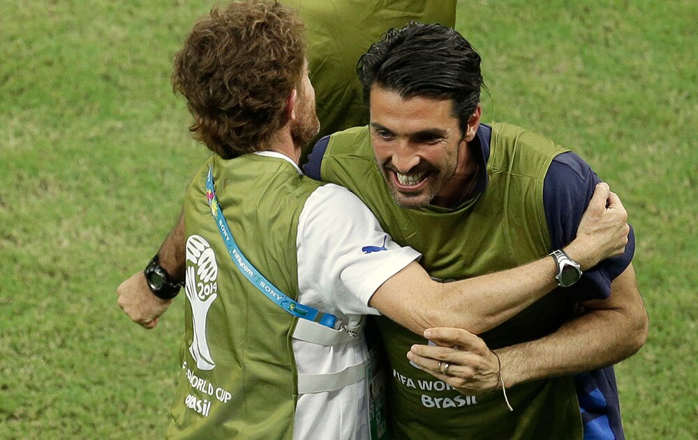 Italy's injured goalkeeper Gianluigi Buffon celebrates with teammates after Italy's Mario Balotelli scored his side's 2nd goal during the group D World Cup soccer match between England and Italy at the Arena da Amazonia in Manaus, Brazil.