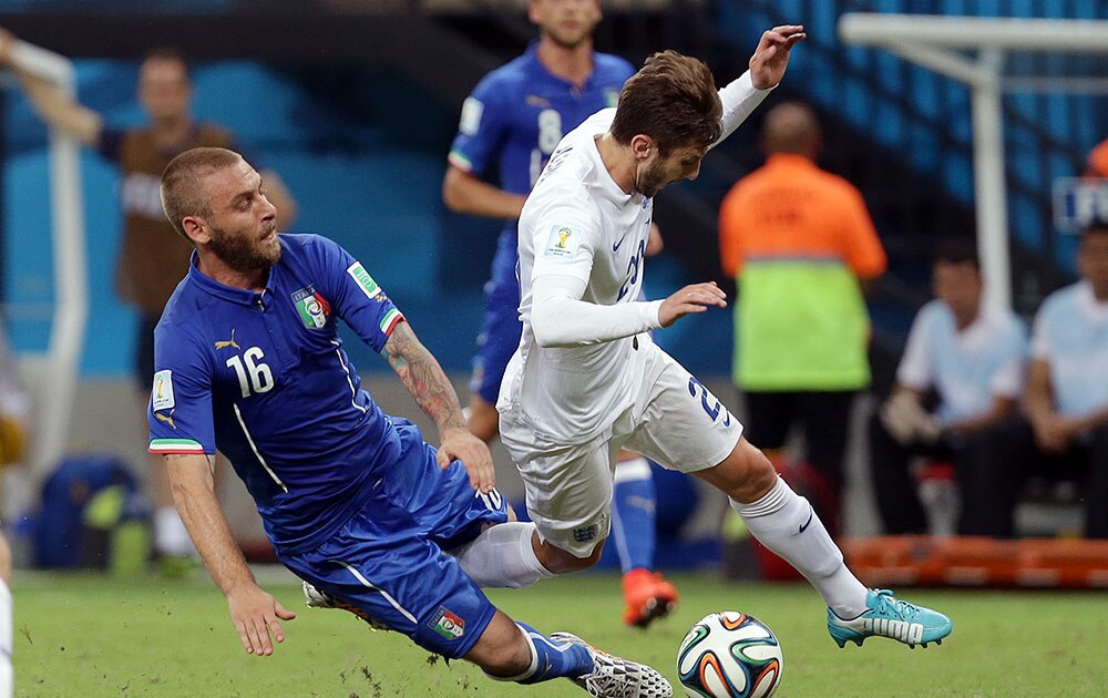 taly's Daniele De Rossi, left, fouls England's Adam Lallana during the group D World Cup soccer match between England and Italy at the Arena da Amazonia in Manaus, Brazil.