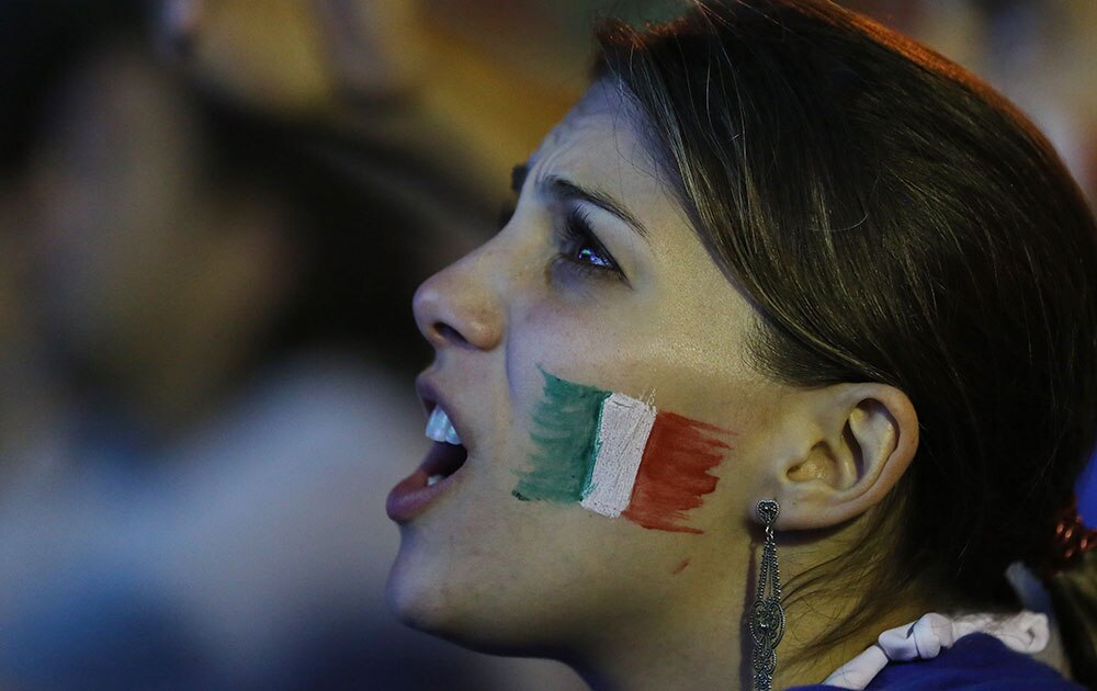 A Italian soccer fan watches a live broadcast of the World Cup match between England and Italy, inside the FIFA Fan Fest area on Copacabana beach, in Rio de Janeiro, Brazil.