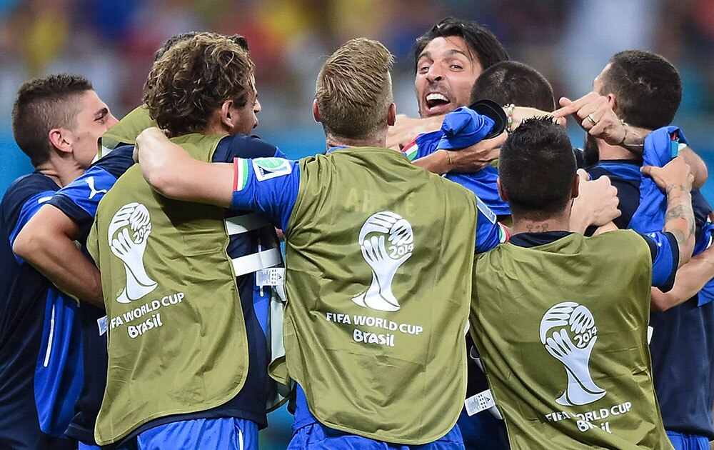 Italian goalie Gianluigi Buffon, face to camera, celebrates with his teammates after the group D World Cup soccer match between England and Italy at the Arena da Amazonia in Manaus, Brazil.