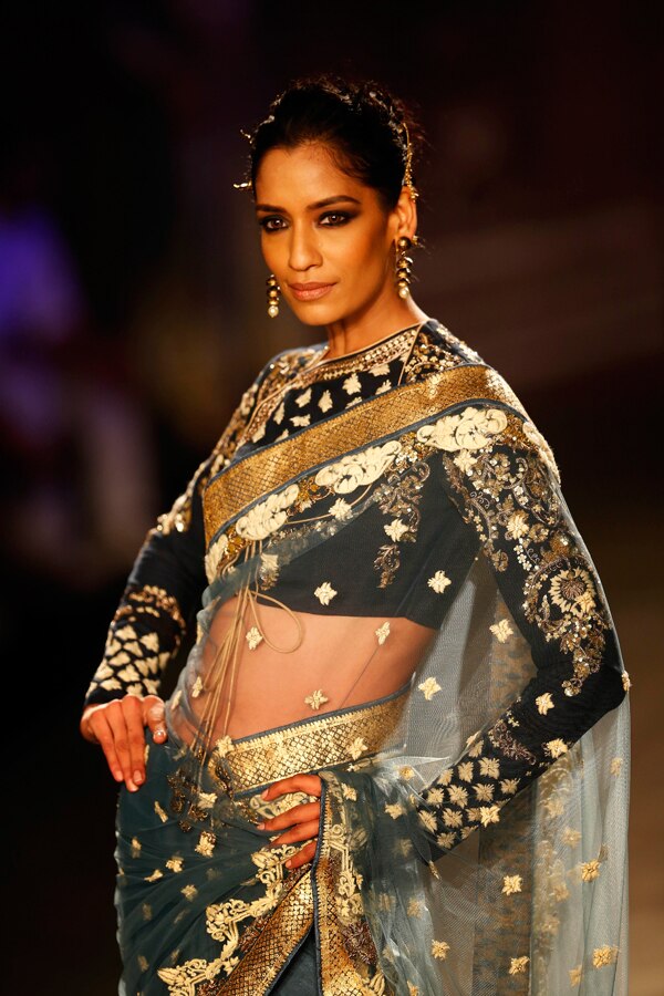 A model displays a dress created by Indian designer Anju Modi at the India Couture Week, held by Fashion Design Council of India, in New Delhi, India, (AP Photo/Saurabh Das)