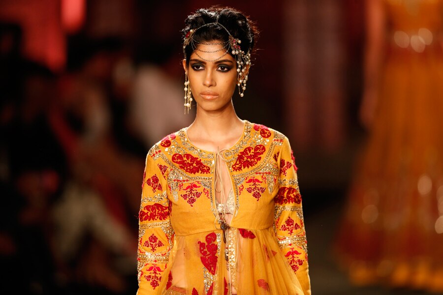 A model displays a dress created by Indian designer Anju Modi at the India Couture Week, held by Fashion Design Council of India, in New Delhi, India, (AP Photo/Saurabh Das)