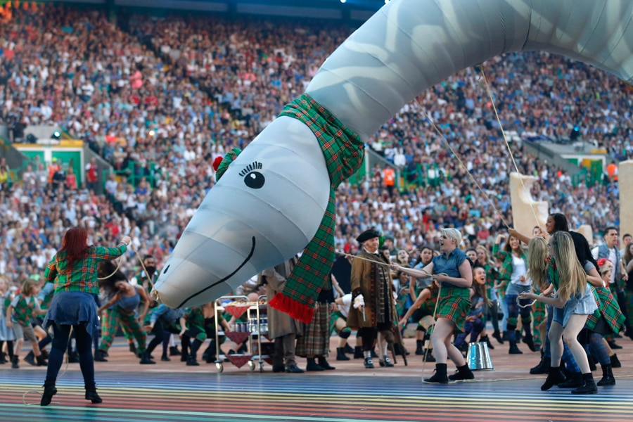 Performers dance with an effigy of the Loch Ness Monster during the opening ceremony for the Commonwealth Games 2014 in Glasgow, Scotland