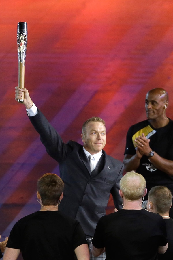 Sir Chris Hoy holds up the Queen's baton during the opening ceremony for the Commonwealth Games 2014 in Glasgow, Scotland