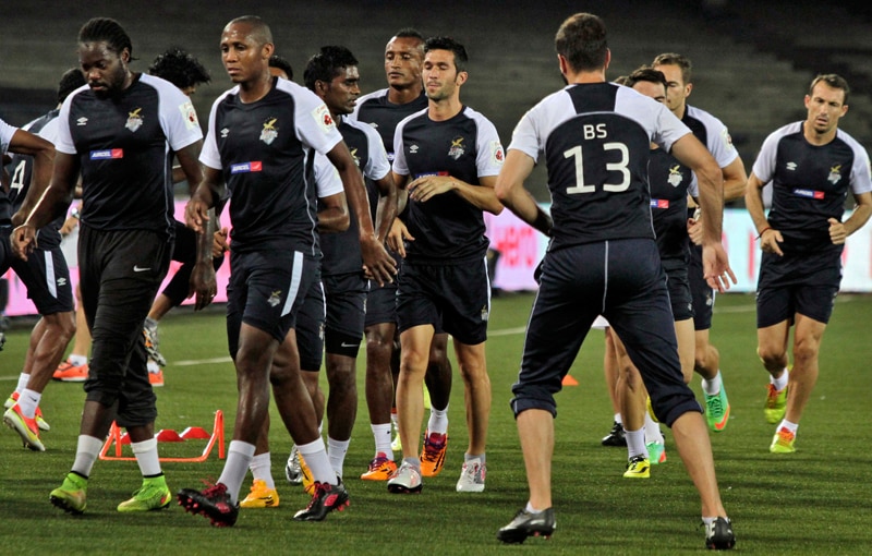 Apolua Edima Edel Bete, foreground left, Ofentse Nato, foreground second left, Spanish soccer star Luis Garcia, center, walk with their teammates of the Atletico De Kolkata football club of the Indian Super League (ISL) during a practice session in Kolkata, India