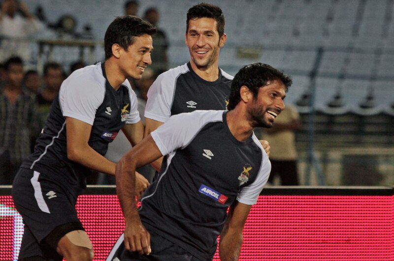 Spanish soccer star Luis Garcia, center, shares a light moment with teammates Denzil Franco, right, and Sanju Pradhan of the Atletico De Kolkata football club of the Indian Super League (ISL) during a practice session in Kolkata