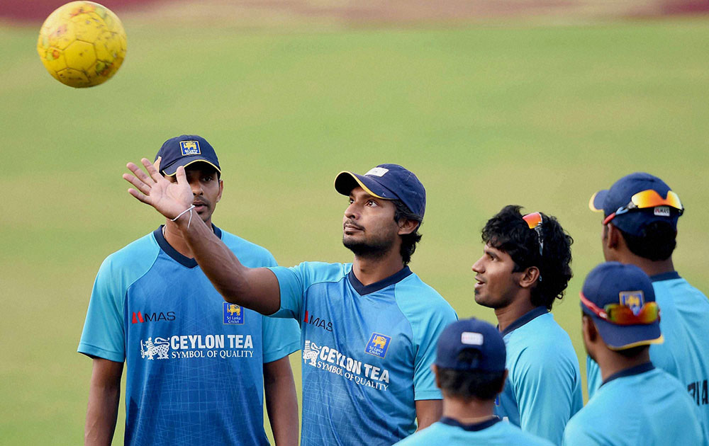Sri Lankan cricketer Kumar Sangakkara with teammates during a training session at Barabati Stadium in Cuttack.
