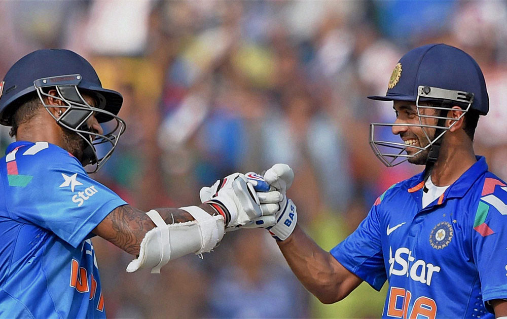 Indian batsman Shikhar Dhawan and Ajinkya Rahane greet each other during 1st ODI match against Sri Lanka in Cuttack.
