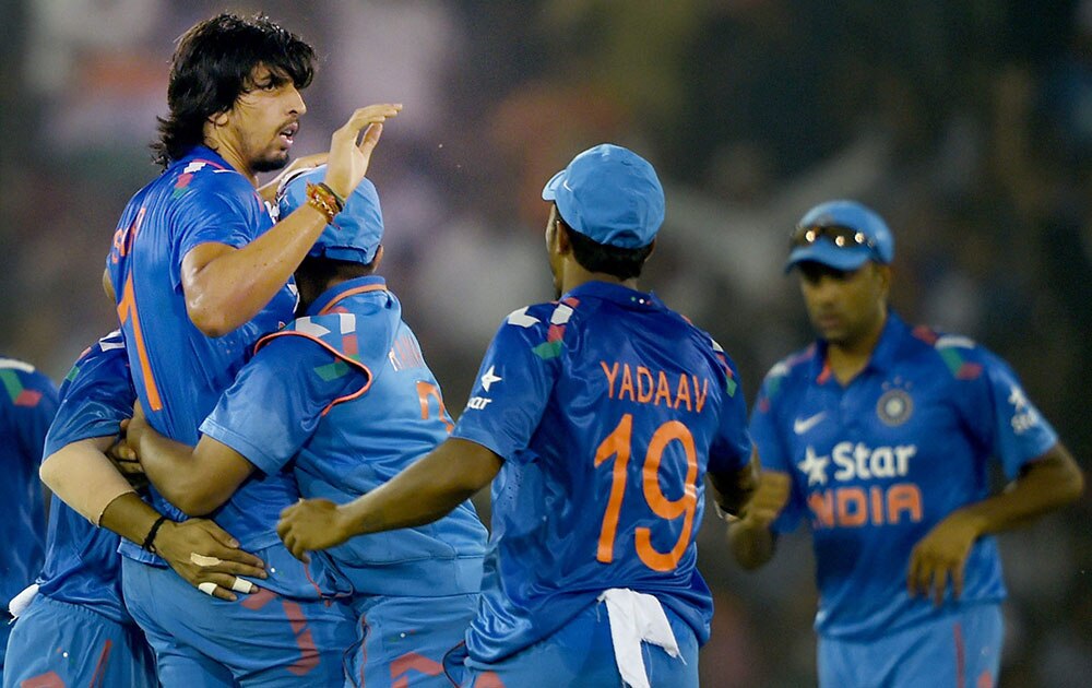 
Indian bowler Ishant Sharma celebrates with his teammates after dismissing Sri Lankan batsman Kumar Sangakkara during the 1st ODI match in Cuttack.
