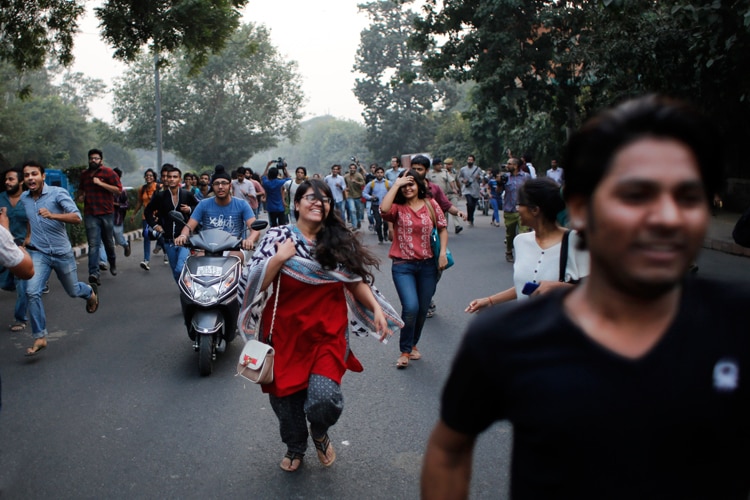 Women kiss each other to express support to the 'Kiss of Love’ campaign near the Hindu right-wing Rashtriya Swayamsevak Sangh (RSS) headquarters in New Delhi.
