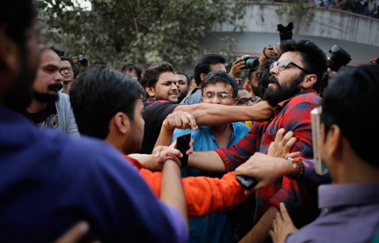 Women kiss each other to express support to the 'Kiss of Love’ campaign near the Hindu right-wing Rashtriya Swayamsevak Sangh (RSS) headquarters in New Delhi.
