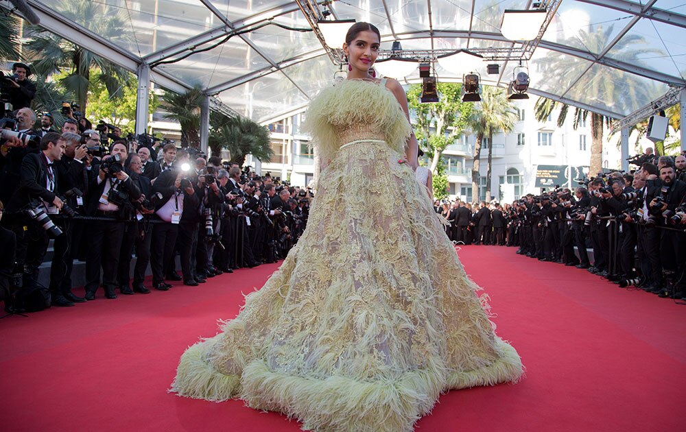 Actress Sonam Kapoor poses for photographers as she arrives for the screening of the film Inside Out at the 68th international film festival, Cannes.
