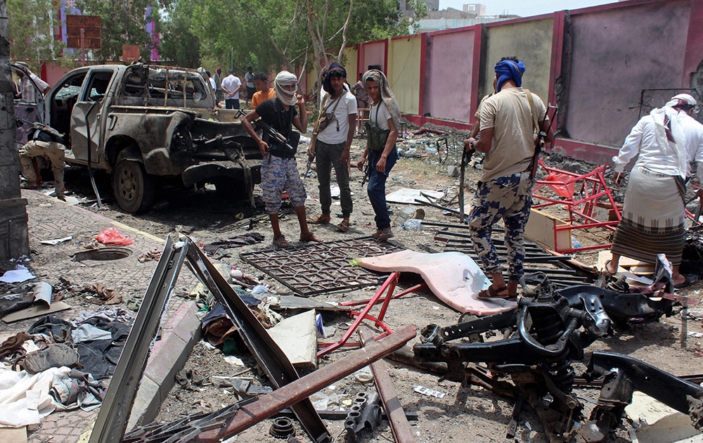 Fighters loyal to the government gather at the site of a suicide car bombing in Yemen‚ a southern city of Aden, Yemen