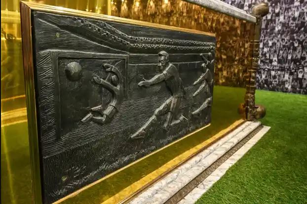 The side of the coffin is etched with striking detail of his playing career