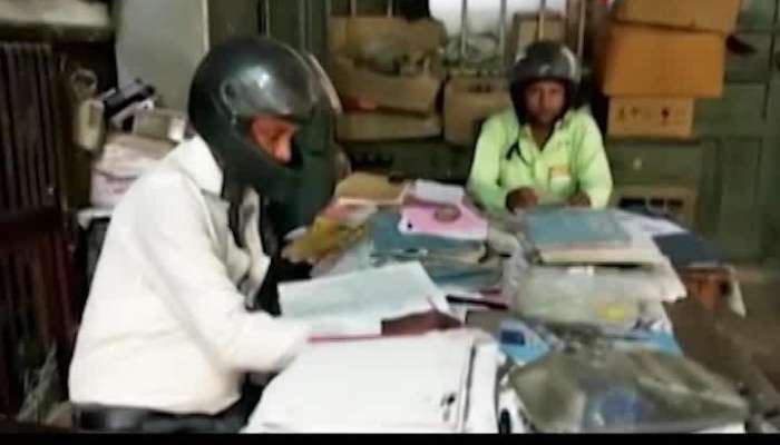 Office workers wear helmet to indirectly protest against the bad situation of building