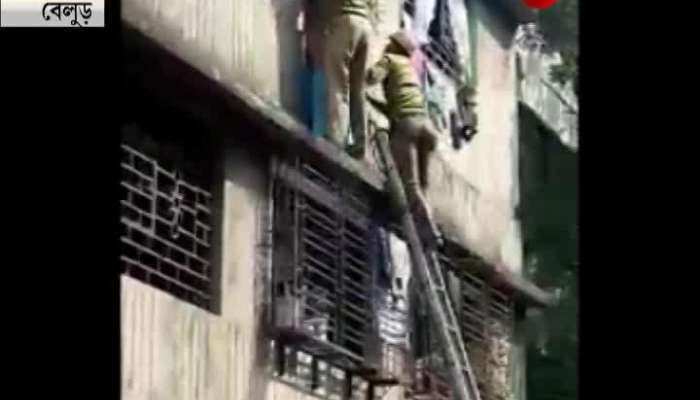 Old woman hanging from 1st floor of a building rescued by fire fighters at Belur